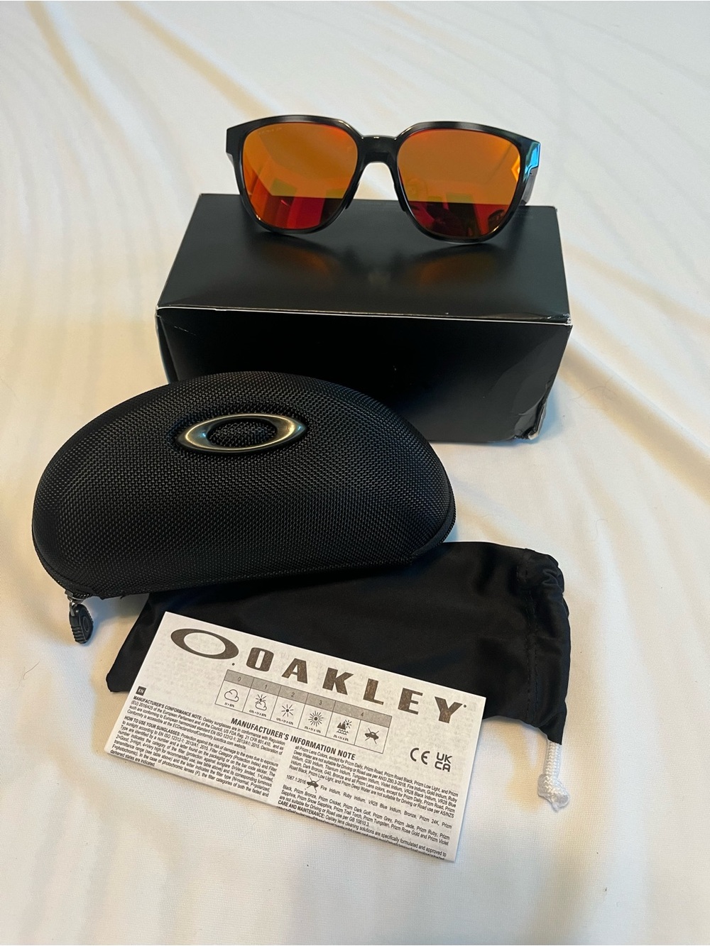 Oakley Black Frame Sunglasses with Orange Mirrored Lenses
